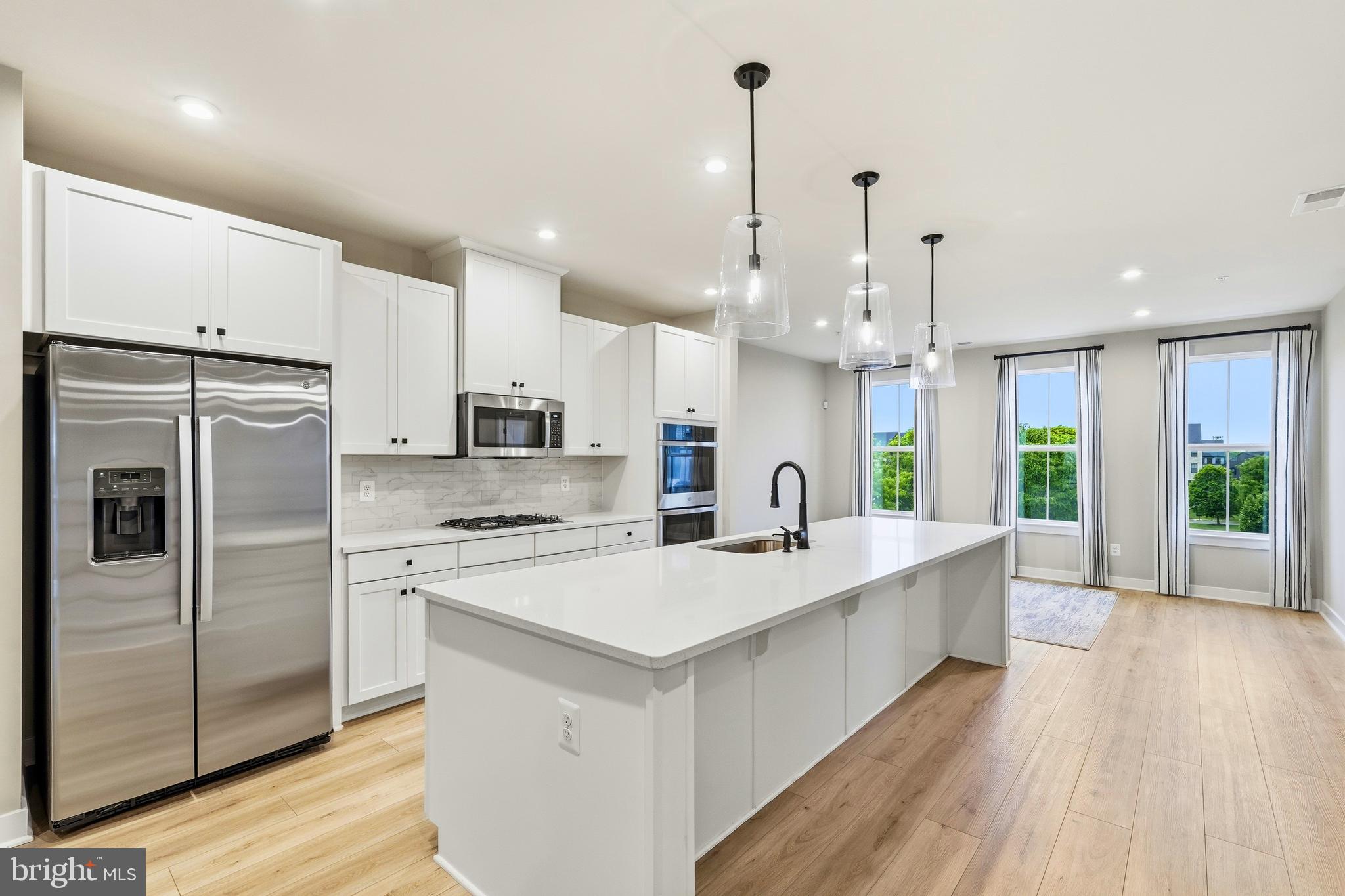 14538 George Carter Way, Unit 287 Chantilly, VA 20151 - Photo 1 of 87 a large kitchen with stainless steel appliances kitchen island a large counter top and stove