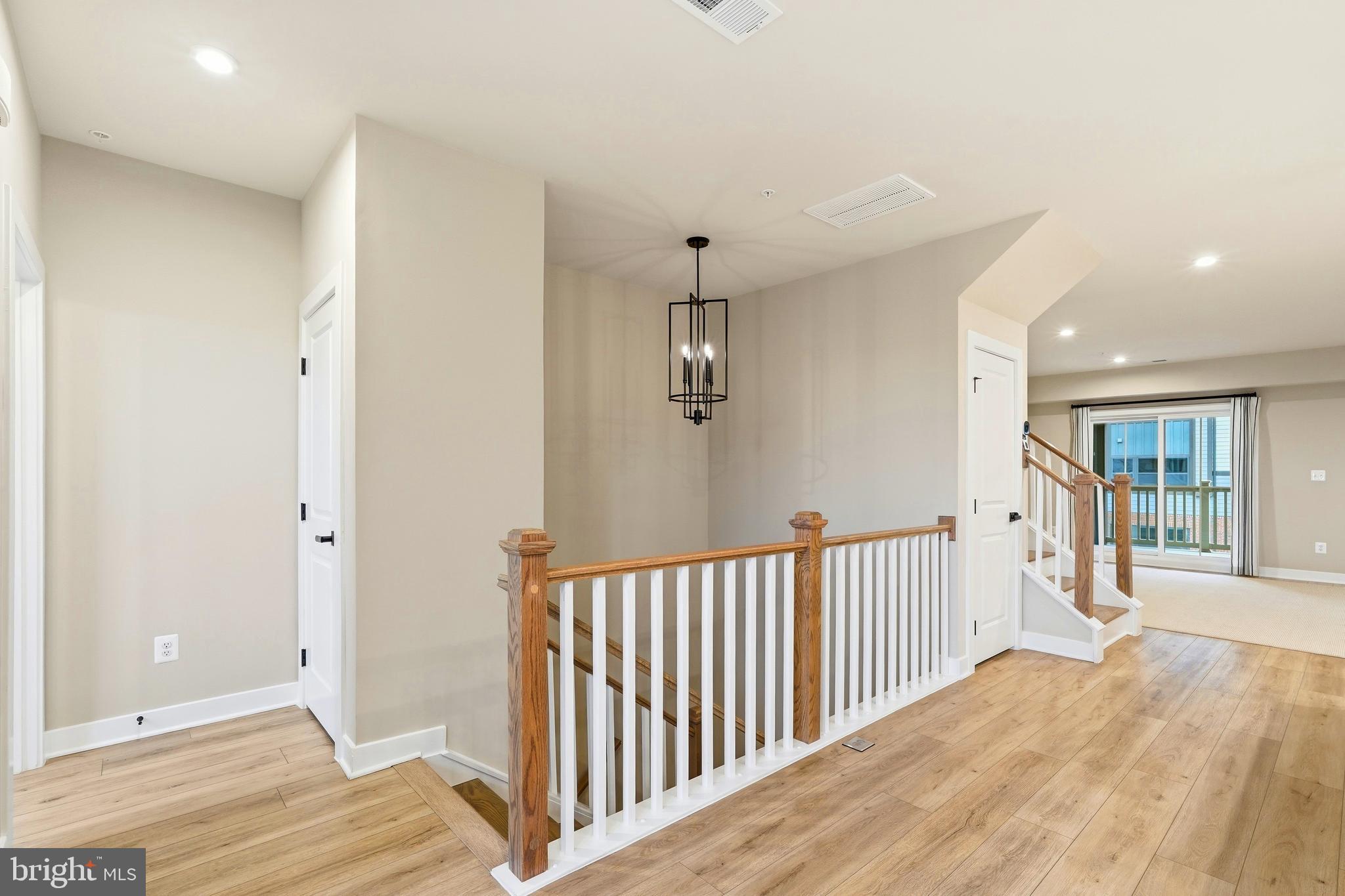 14538 George Carter Way, Unit 287 Chantilly, VA 20151 - Photo 14 of 87 a view of a hallway with wooden floor and entryway