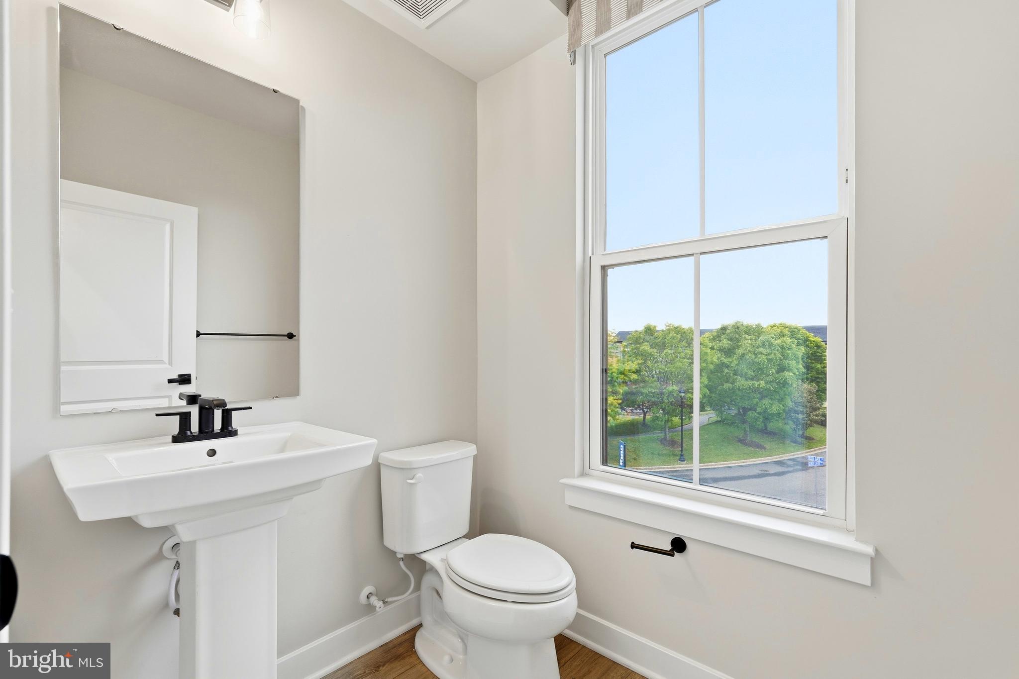 14538 George Carter Way, Unit 287 Chantilly, VA 20151 - Photo 21 of 87 a bathroom with a sink a toilet and a mirror