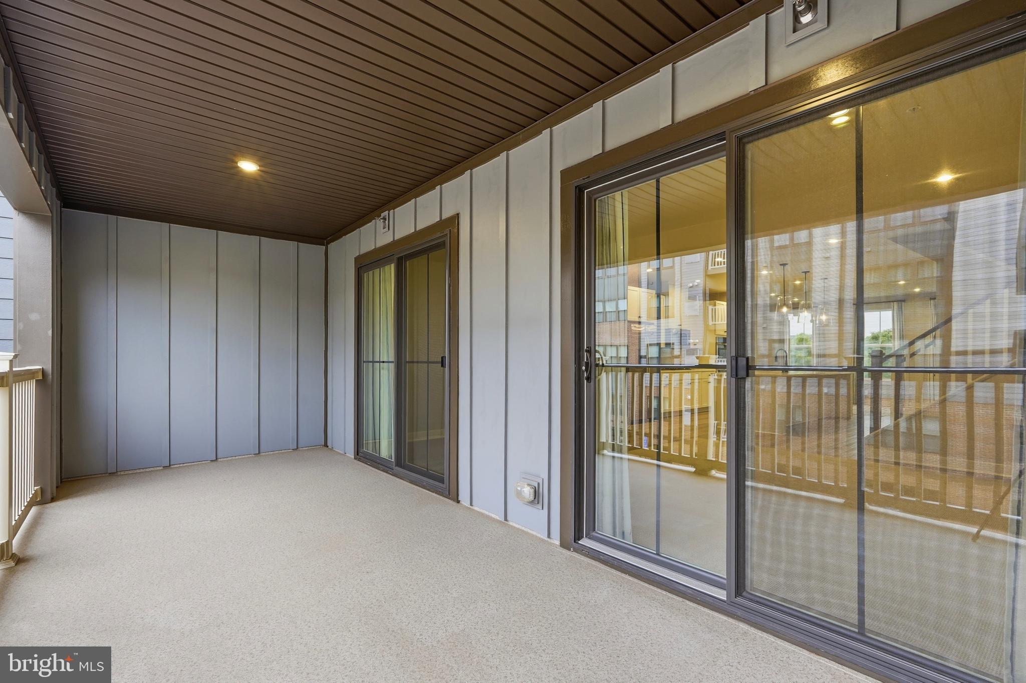14538 George Carter Way, Unit 287 Chantilly, VA 20151 - Photo 28 of 87 a view of an empty room with sliding glass door