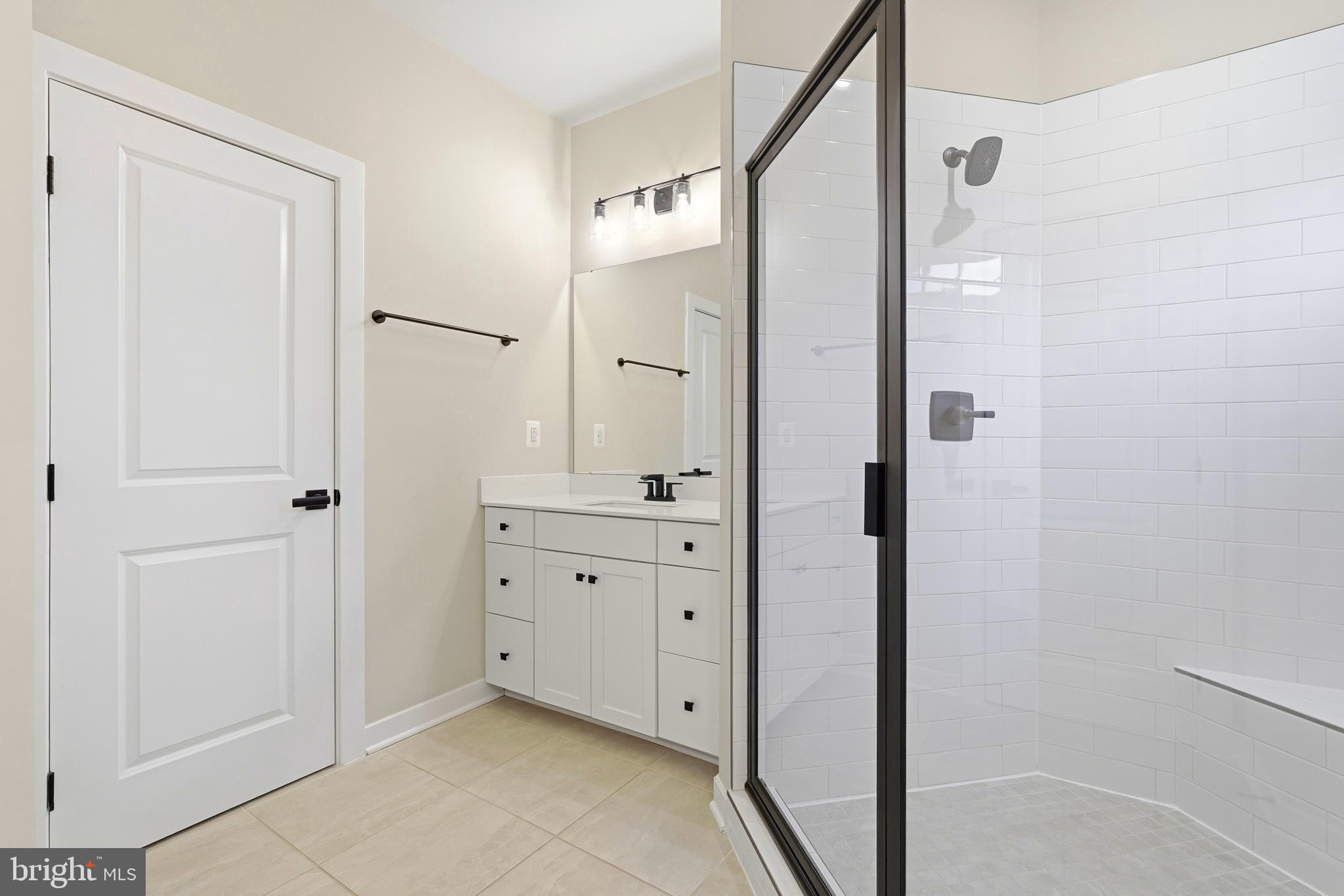 14538 George Carter Way, Unit 287 Chantilly, VA 20151 - Photo 42 of 87 a bathroom with a granite countertop sink mirror and shower
