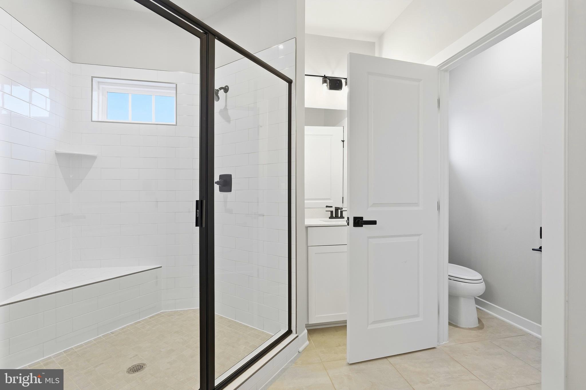 14538 George Carter Way, Unit 287 Chantilly, VA 20151 - Photo 43 of 87 a bathroom with a granite countertop sink a toilet and shower