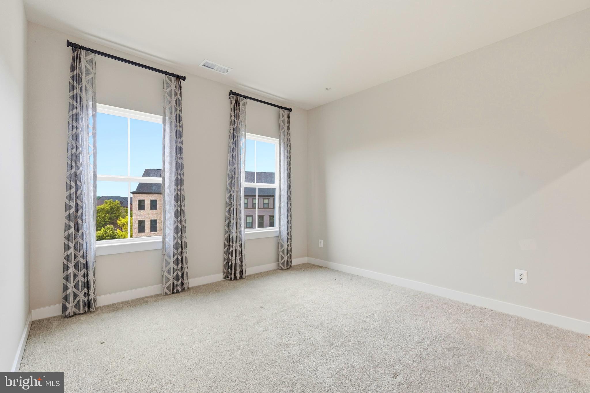 14538 George Carter Way, Unit 287 Chantilly, VA 20151 - Photo 48 of 87 an empty room with windows