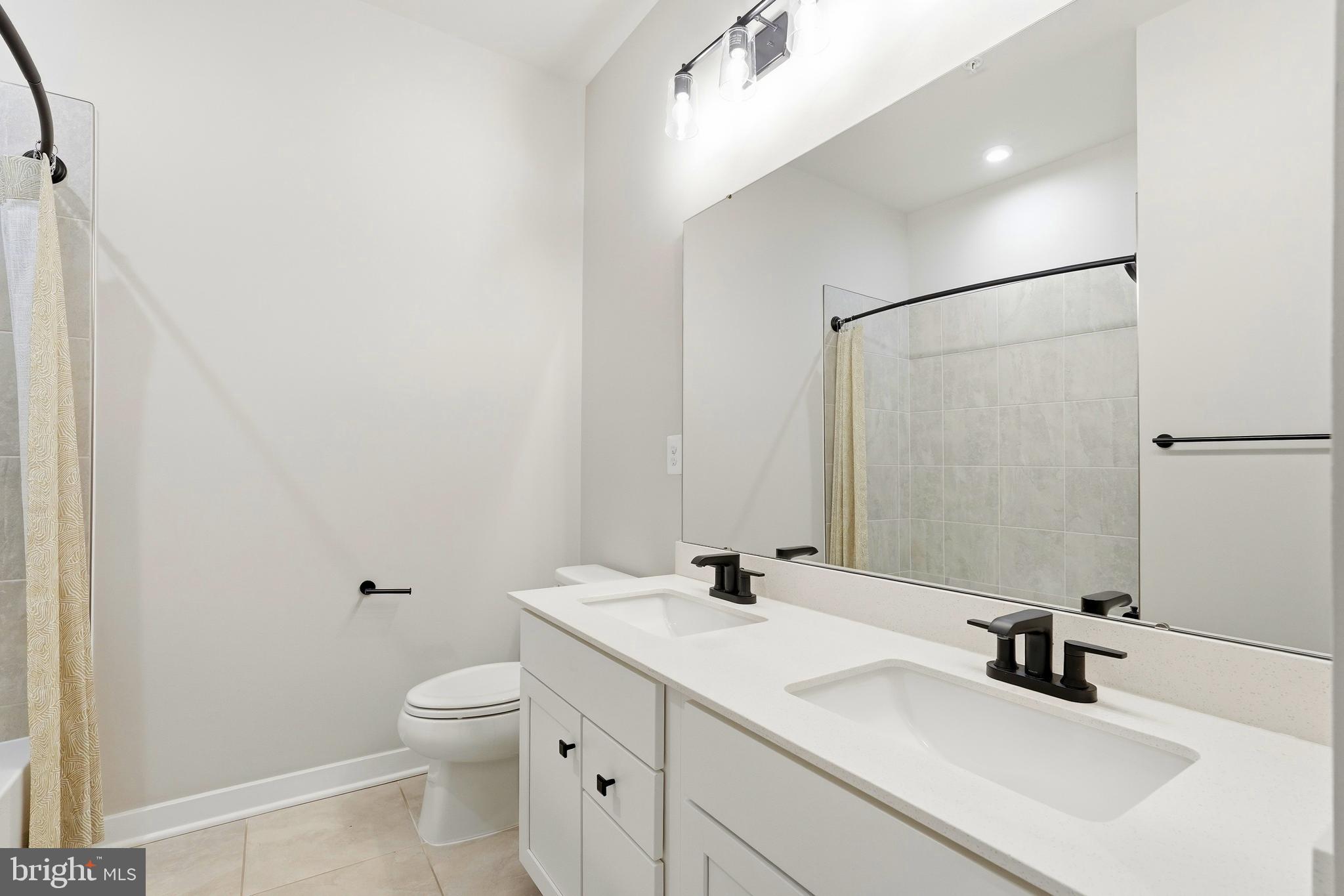14538 George Carter Way, Unit 287 Chantilly, VA 20151 - Photo 57 of 87 a bathroom with a sink toilet and shower
