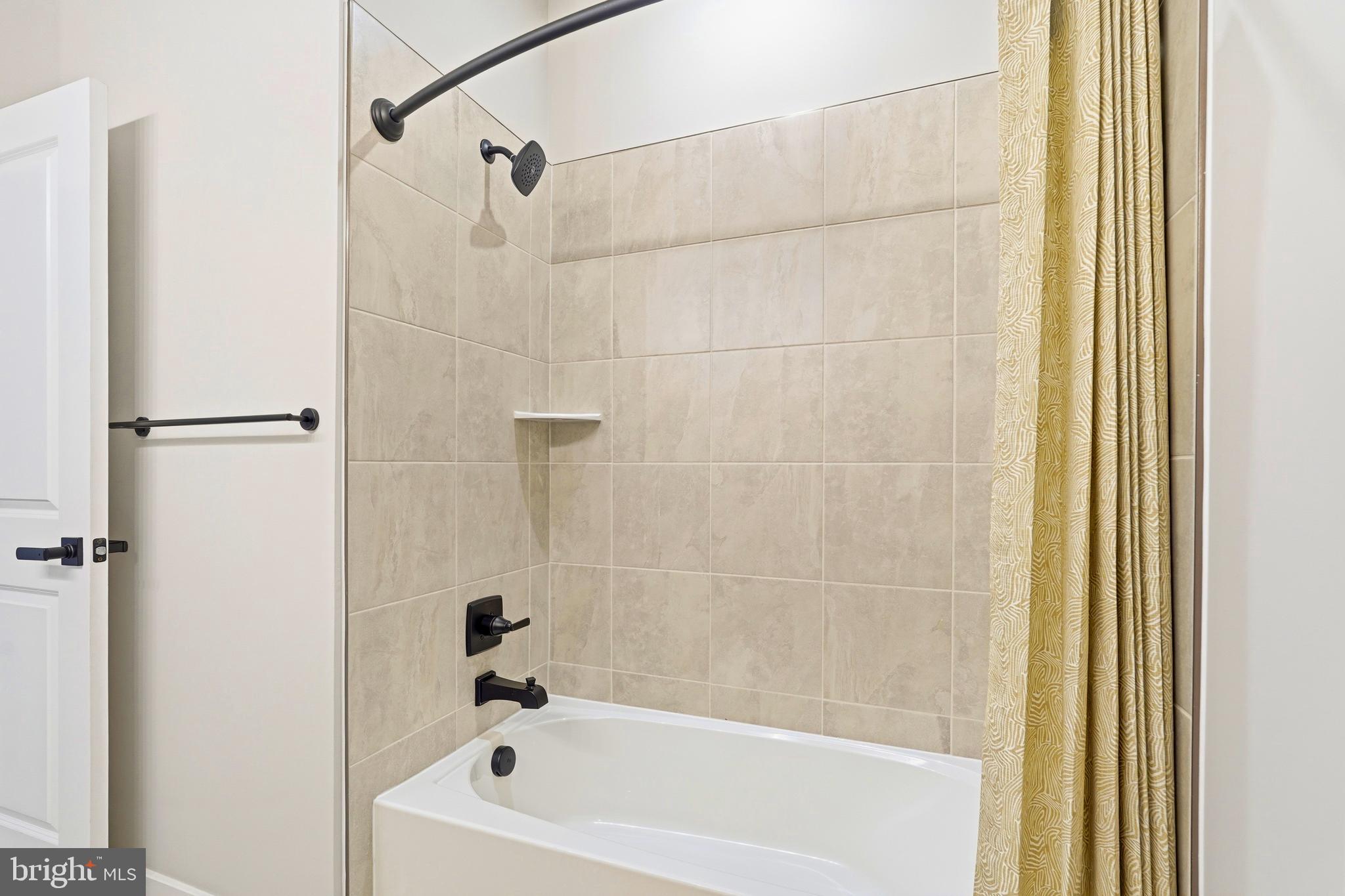 14538 George Carter Way, Unit 287 Chantilly, VA 20151 - Photo 58 of 87 a bathroom with a white bath tub and a shower