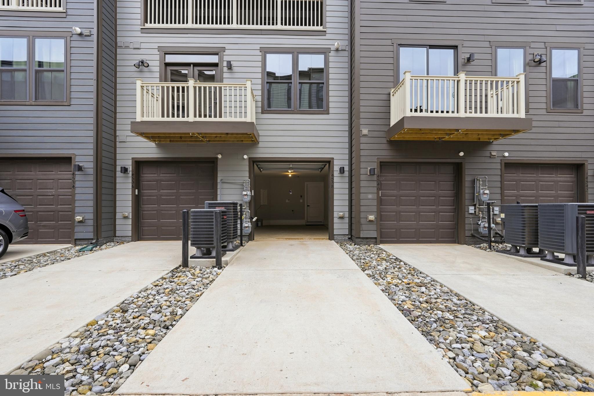 14538 George Carter Way, Unit 287 Chantilly, VA 20151 - Photo 67 of 87 a front view of a brick house with a yard
