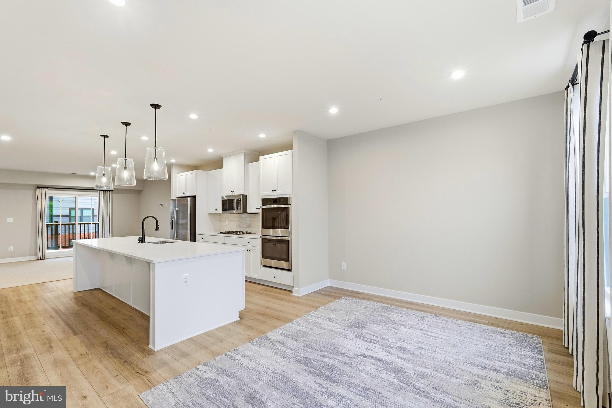 14538 George Carter Way, Unit 287 Chantilly, VA 20151 - Photo 10 of 87 a living room with stainless steel appliances kitchen island hardwood floor and a sink