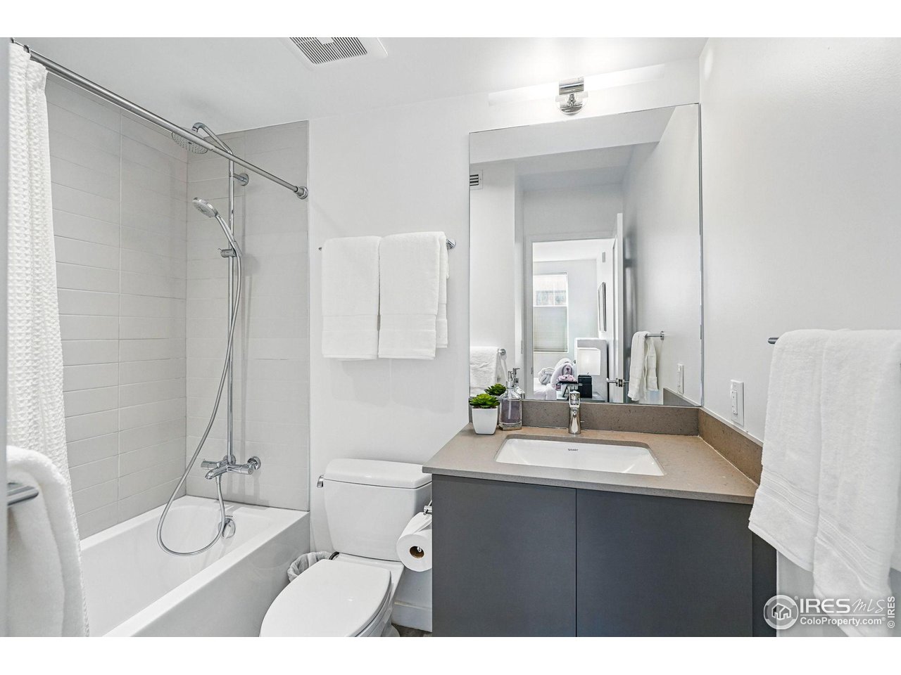 1916 23rd Street, Unit 6 Boulder, CO 80302 - Photo 21 of 27 a bathroom with a sink vanity toilet and shower
