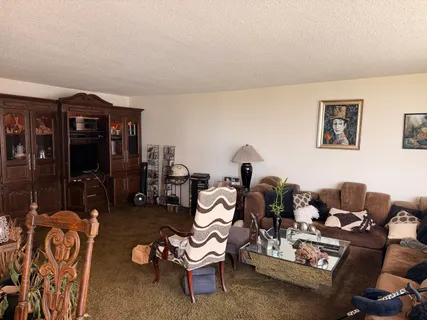 a living room with furniture and glass door
