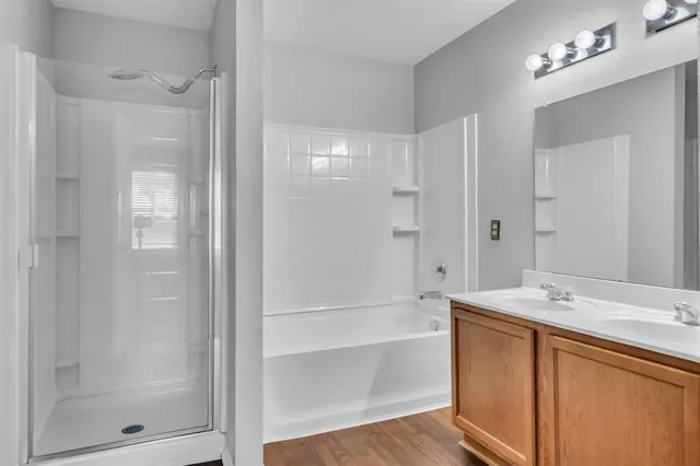 a bathroom with a shower sink vanity and mirror