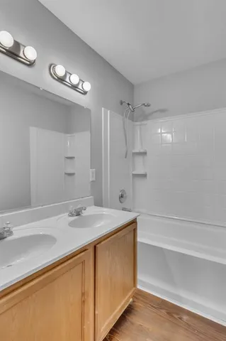 a bathroom with a sink a large mirror and a shower