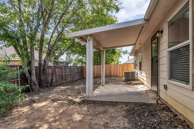 a view of a backyard with a small cabin and a chair
