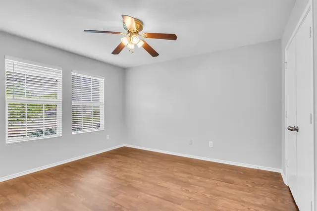 a view of an empty room with chandelier and a window