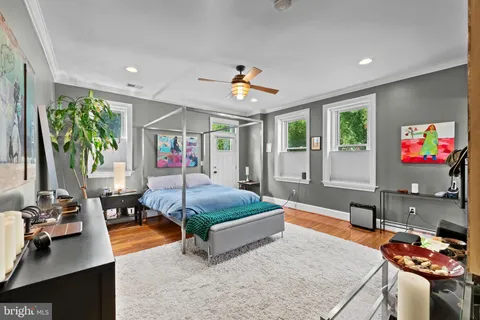 a bedroom with a bed and glass windows