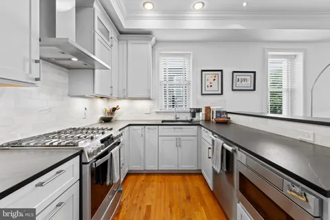 a stove top oven sitting inside of a kitchen