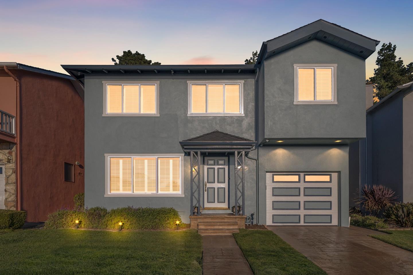a front view of a house with a yard
