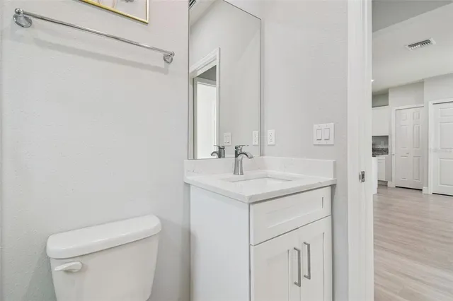 a bathroom with a sink a toilet and a mirror