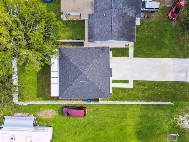 an aerial view of a house with a yard