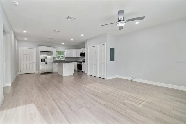 a view of a kitchen with a sink and a refrigerator