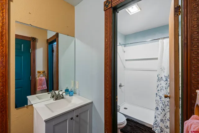 a bedroom with bed and a night stand