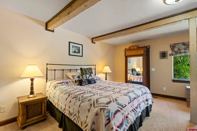 a bedroom with a large bed and a large window