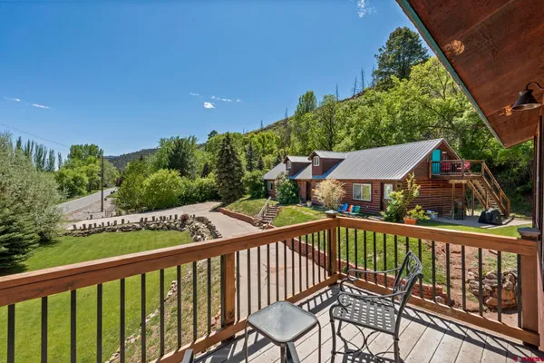 a view of a two chairs in the balcony