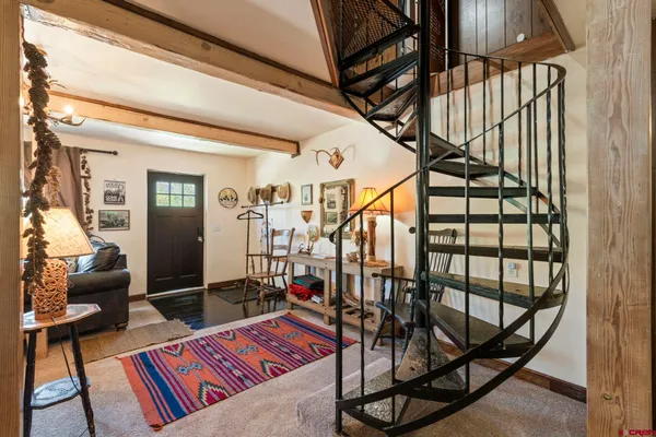 a view of living room with a baby crib furniture and a window