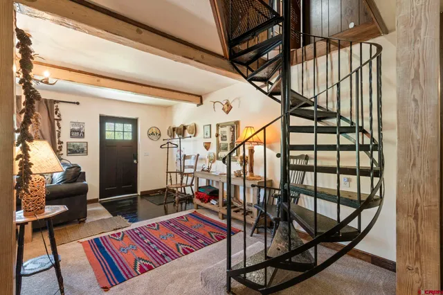 a view of living room with a baby crib furniture and a window