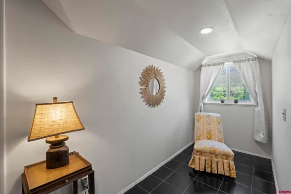 a bedroom with a bed and a lamp