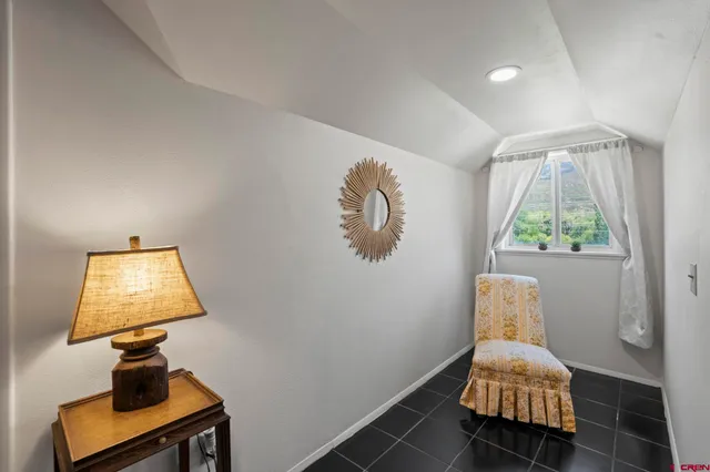 a bedroom with a bed and a lamp