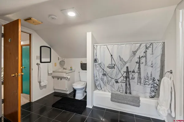 a bedroom with a bed and a lamp with the outer view