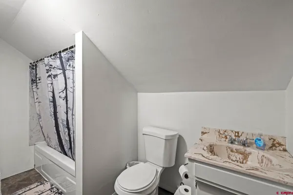 a bed room with two bed and a lamp