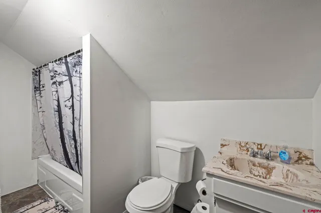 a bed room with two bed and a lamp