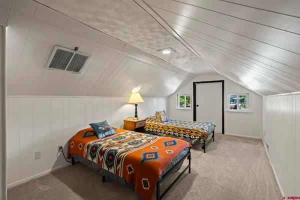 a living room with furniture a rug and a table