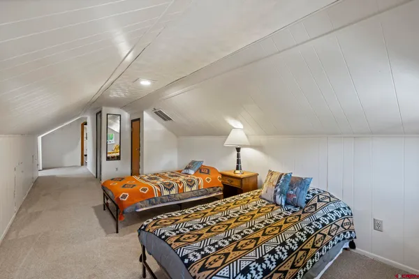 a living room with furniture a flat screen tv and a large window