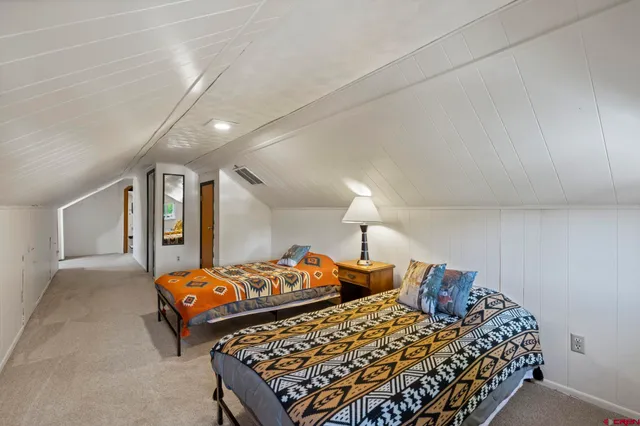 a living room with furniture a flat screen tv and a large window