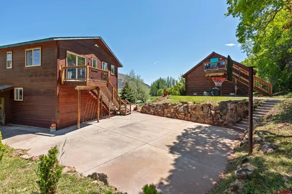 a front view of a house with a yard and a garage