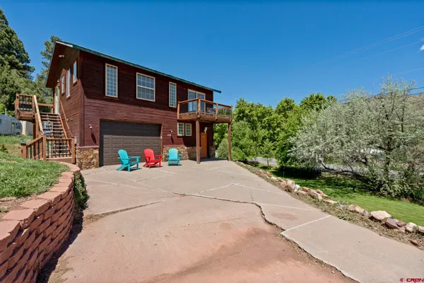 a yard with a tree in the background