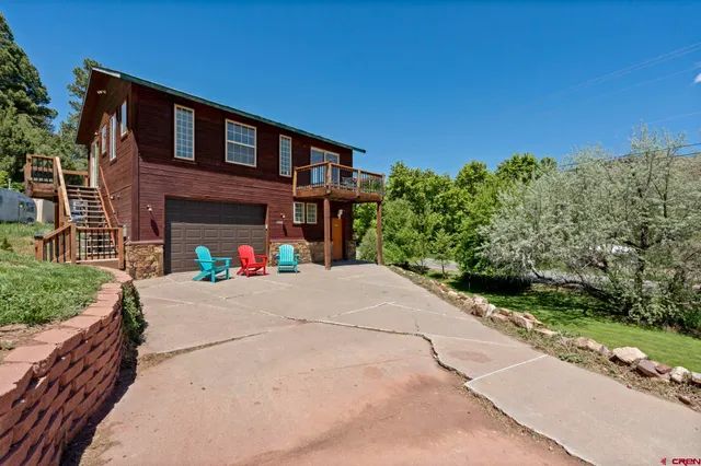 a yard with a tree in the background