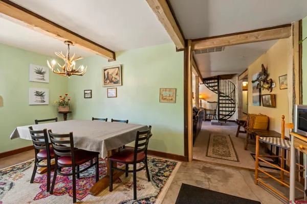 a view of a dining room with furniture and chandelier