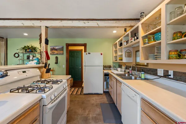 a kitchen with a sink stove and refrigerator