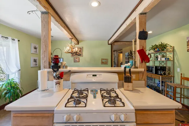 a kitchen with a sink stove and cabinets