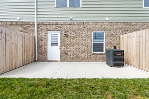 a view of backyard with barbeque grill and wooden fence