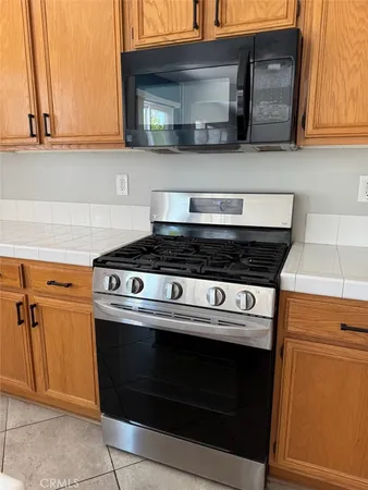 a stove top oven sitting inside of a kitchen