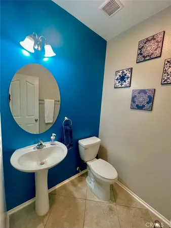 a bathroom with a toilet a sink and a mirror