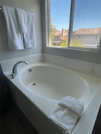 a bathroom with a bathtub and window