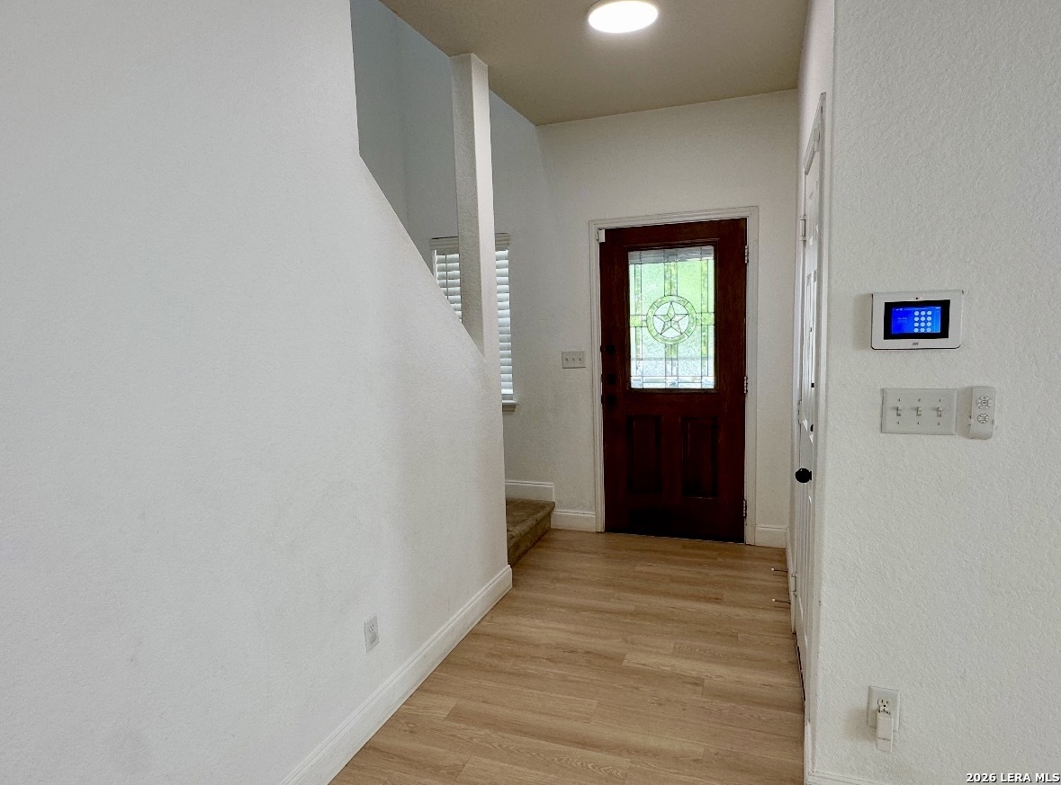 443 Harvest Point Schertz, TX 78154 - Photo 2 of 13 a view of a hallway with wooden floor and entryway