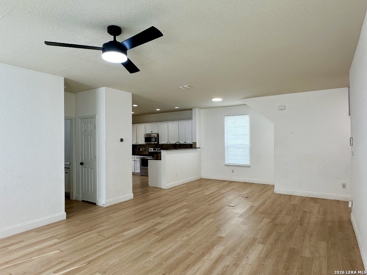 443 Harvest Point Schertz, TX 78154 - Photo 3 of 13 a view of empty room with wooden floor and window