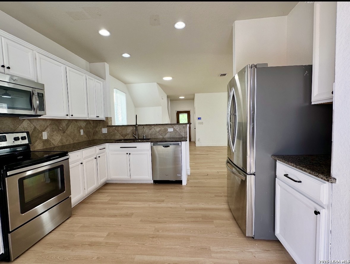 443 Harvest Point Schertz, TX 78154 - Photo 5 of 13 a kitchen with stainless steel appliances a refrigerator sink and microwave