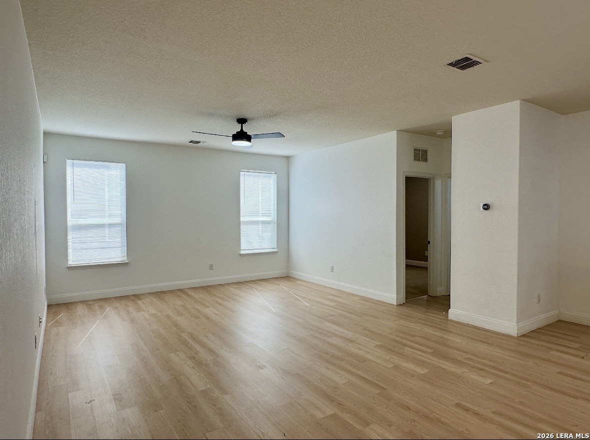 443 Harvest Point Schertz, TX 78154 - Photo 7 of 13 a view of an empty room with wooden floor and a window